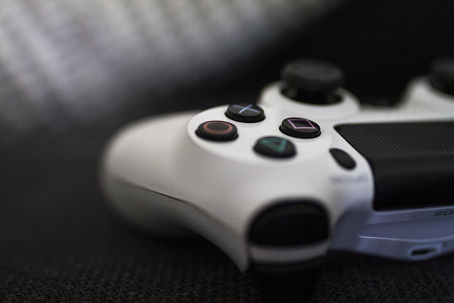Close-up of a PlayStation controller on a dark surface